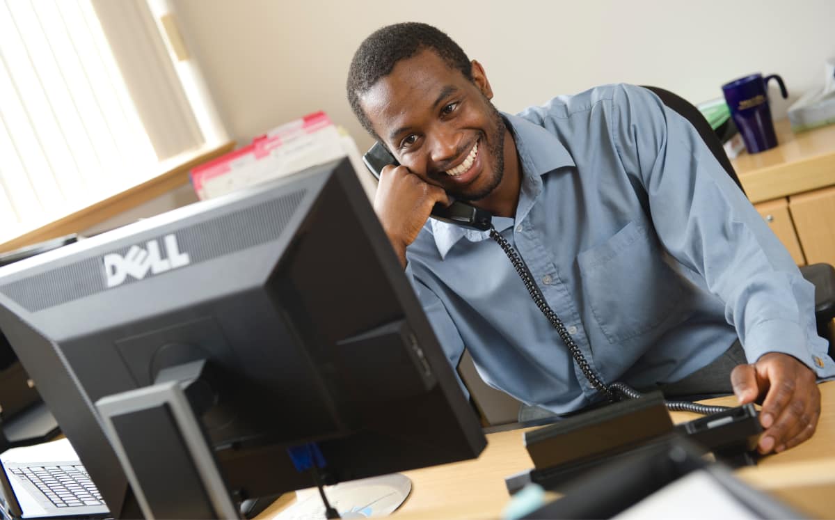 office assistant on phone at desk