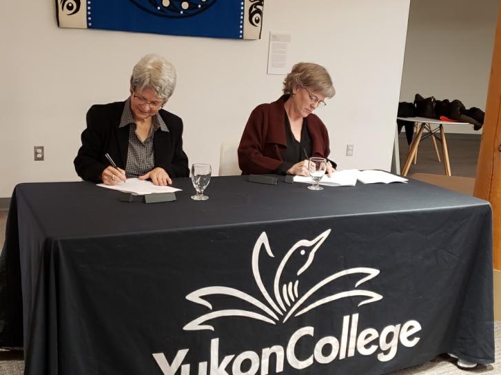 Dr. Janet Welch and Jeanne Beaudoin sign the MOU document