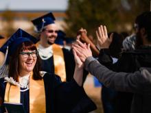 graduates receive high fives
